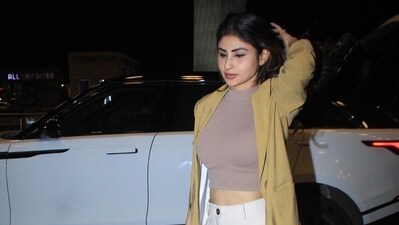 Actor Mouni Roy was seen arriving at Mumbai airport on Friday night. The actor wore a casual airport look and was seen solo in paparazzi pictures. She wore a mustard yellow jacket over a grey crop top. Mouni completed the look with beige trousers and white sneakers. Actor Mouni Roy was seen arriving at Mumbai airport on Friday night. The actor wore a casual airport look and was seen solo in paparazzi pictures. She wore a mustard yellow jacket over a grey crop top. Mouni completed the look with beige trousers and white sneakers. 