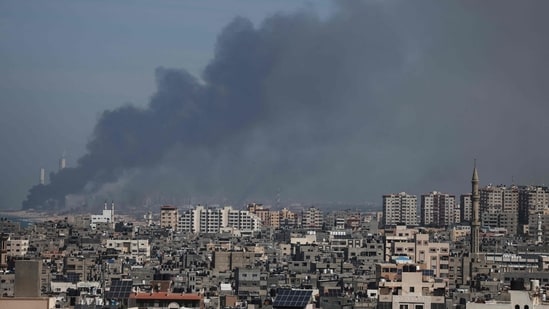 Israel-Palestine Latest: Smoke billows over the Israeli side of the border with Gaza as seen from Gaza City. (AFP)