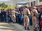 Paramilitary personnel stand guard as Jammu and Kashmir National Conference (JKNC) and Congress supporters wait outside amid the counting of votes. Paramilitary personnel stand guard as Jammu and Kashmir National Conference (JKNC) and Congress supporters wait outside amid the counting of votes.
