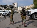 Israeli soldiers walk near the police station that was overrun by Hamas militants on October 8.