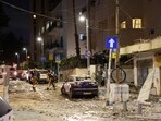 Members of the Israeli security forces walk along a debris-strewn street in Tel Aviv, after it was hit by a rocket fired by Palestinians from the Gaza Strip Members of the Israeli security forces walk along a debris-strewn street in Tel Aviv, after it was hit by a rocket fired by Palestinians from the Gaza Strip