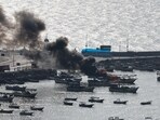 Israel-Palestine Conflict: Smoke billows from a boat following Israeli strikes, at Port of Gaza.
