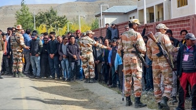 Paramilitary personnel stand guard as Jammu and Kashmir National Conference (JKNC) and Congress supporters wait outside amid the counting of votes. Paramilitary personnel stand guard as Jammu and Kashmir National Conference (JKNC) and Congress supporters wait outside amid the counting of votes.