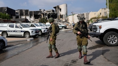 Israeli soldiers walk near the police station that was overrun by Hamas militants on October 8. (AP) Israeli soldiers walk near the police station that was overrun by Hamas militants on October 8. (AP)