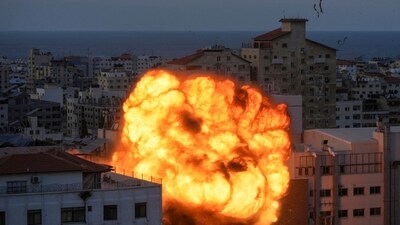 Israel-Palestine Conflict: Fire and smoke rise following an Israeli airstrike, in Gaza City. (AP) Israel-Palestine Conflict: Fire and smoke rise following an Israeli airstrike, in Gaza City. (AP)