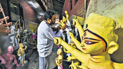 An artist gives the final touches to a clay idol of goddess Durga near a temple in Sarojini Nagar. (Raj K Raj/HT Photo) An artist gives the final touches to a clay idol of goddess Durga near a temple in Sarojini Nagar. (Raj K Raj/HT Photo)