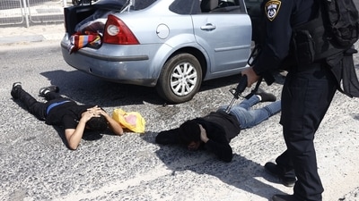 Israeli police check the occupants of a vehicle near Ashkelon, Israel, on Sunday. (Bloomberg) Israeli police check the occupants of a vehicle near Ashkelon, Israel, on Sunday. (Bloomberg)