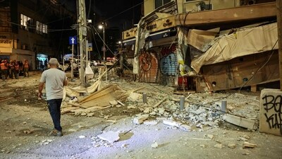 A man walks along a debris-strewn street in Tel Aviv, after it was hit by a rocket fired by Palestinian militants from the Gaza Strip. (AFP) A man walks along a debris-strewn street in Tel Aviv, after it was hit by a rocket fired by Palestinian militants from the Gaza Strip. (AFP)