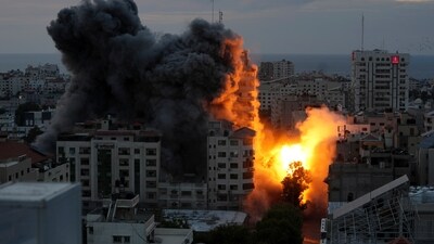 A ball of fire and smoke rises from an explosion on a Palestine apartment tower following an Israeli air strike in Gaza City on Saturday. (AP) A ball of fire and smoke rises from an explosion on a Palestine apartment tower following an Israeli air strike in Gaza City on Saturday. (AP)