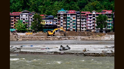 Vehicles buried in the sand along the Teesta river in Rongpo in east Sikkim on Sunday. (AP) Vehicles buried in the sand along the Teesta river in Rongpo in east Sikkim on Sunday. (AP)