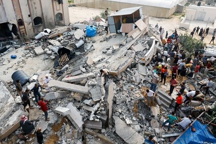 Palestinians search through the rubble of a house destroyed in Israeli strikes in Khan Younis in the southern Gaza Strip on October 8. (Reuters)