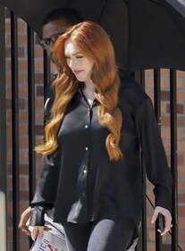 Lindsay, 37, who played the role of Cady Heron, was photographed in an all-black outfit with a clutch inspired by the movie. Lindsay, 37, who played the role of Cady Heron, was photographed in an all-black outfit with a clutch inspired by the movie.