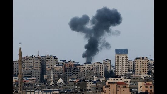 A plume of black smoke rises above Gaza City’s skyline during an Israeli airstrike on Sunday. (AFP)