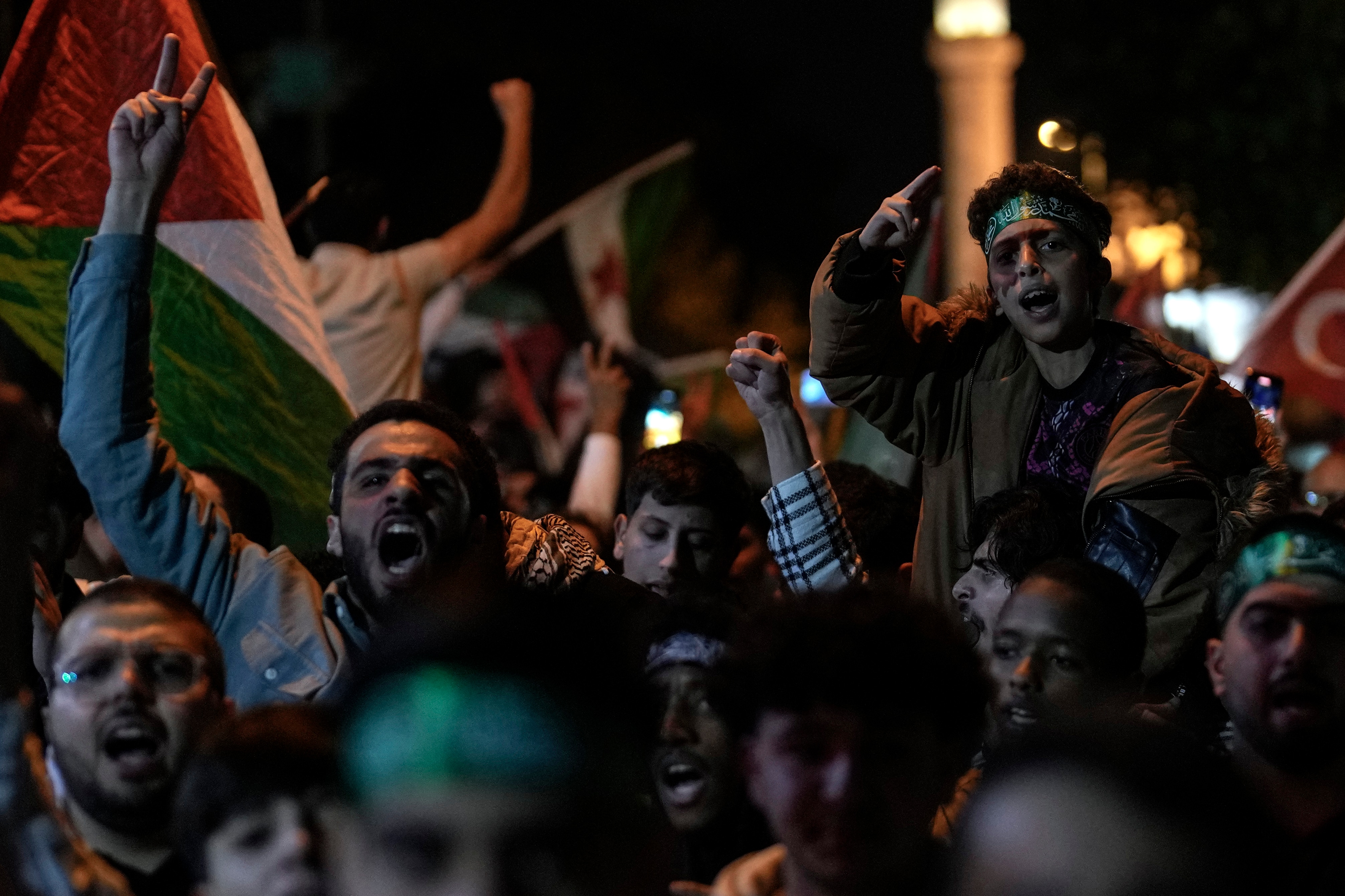 People chant anti-Israel slogans while waving Palestinian flags during a rally celebrating the attacks that the militant Hamas group carried out against Israel, in Istanbul, Turkey, Saturday, Oct. 7, 2023. (AP Photo/Khalil Hamra) (AP)