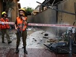 Israel-Palestine Latest: Israeli soldiers stand guard near damage caused by a rocket after if was fired from the Gaza Strip towards Israel.