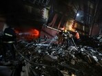 Palestinian civil defense crews try to extinguish fire in a house that was hit by an Israeli airstrike in Khan Younis, southern Gaza Strip, Sunday.