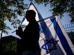 A man carries Israeli flags during a pro-Israel rally outside of Israeli Embassy on October 8 in Washington DC.