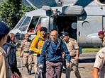 Tourists evacuated from flood-affected Lachen by helicopter arrive at Ringhim Helipad, Mangan in North Sikkim.(PTI)