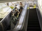 People riding on escalators. People riding on escalators.