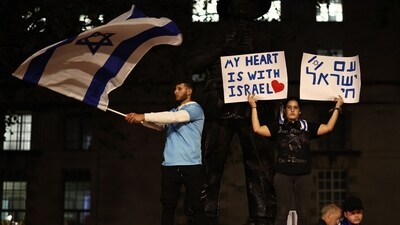 People take part in a 'Vigil for Israel' opposite the entrance to Downing Street, the official residence of Britain's Prime Minister, in London on October 9 (AFP)