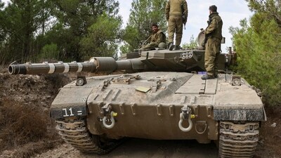 Israel-Palestine War: Israeli soldiers ride on a Merkava tank as it drives to an undisclosed location in northern Israel. (AFP) Israel-Palestine War: Israeli soldiers ride on a Merkava tank as it drives to an undisclosed location in northern Israel. (AFP)