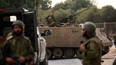 An Israeli soldier sits on the roof of an Armoured Personnel Carrier (APC) near Israel's border with Lebanon, northern Israel, October 9. (REUTERS)