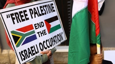 A boy holds a Palestinian flag during a demonstration to express support for the people of Palestine, in Cape Town, South Africa, October 9. (Reuters)
