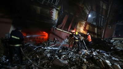 Palestinian civil defense crews try to extinguish fire in a house that was hit by an Israeli airstrike in Khan Younis, southern Gaza Strip, Sunday. (AP) Palestinian civil defense crews try to extinguish fire in a house that was hit by an Israeli airstrike in Khan Younis, southern Gaza Strip, Sunday. (AP)