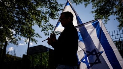 A man carries Israeli flags during a pro-Israel rally outside of Israeli Embassy on October 8 in Washington DC. (AFP) A man carries Israeli flags during a pro-Israel rally outside of Israeli Embassy on October 8 in Washington DC. (AFP)