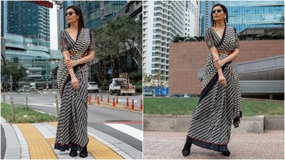 Meanwhile, Karishma also explored the streets of Busan during the film festival. She chose a statement saree by JJ Valaya for the occasion. The six yards feature the designer's statement black and white leaf pattern, broad black and red borders, and shell embellishments on the pleated pallu. (Instagram) Meanwhile, Karishma also explored the streets of Busan during the film festival. She chose a statement saree by JJ Valaya for the occasion. The six yards feature the designer's statement black and white leaf pattern, broad black and red borders, and shell embellishments on the pleated pallu. (Instagram)