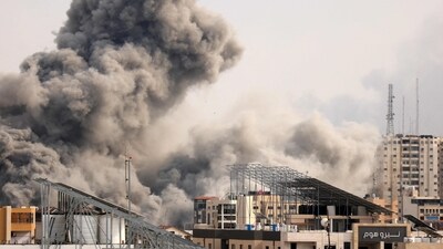Israel-Palestine Latest: A plume of smoke billows behind highrise buildings in the sky during an Israeli airstrike on Gaza City. (AFP) Israel-Palestine Latest: A plume of smoke billows behind highrise buildings in the sky during an Israeli airstrike on Gaza City. (AFP)