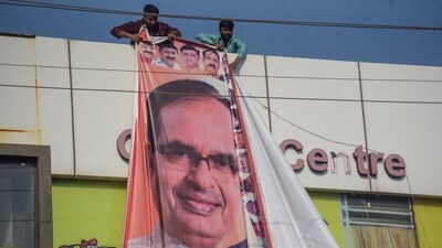 Indore: A poster of Madhya Pradesh CM Shivraj Singh Chouhan is removed after enforcement of the model code of conduct, in Indore, Monday, Oct. 9, 2023. (PTI Photo) (PTI10_09_2023_000456A) (PTI) Indore: A poster of Madhya Pradesh CM Shivraj Singh Chouhan is removed after enforcement of the model code of conduct, in Indore, Monday, Oct. 9, 2023. (PTI Photo) (PTI10_09_2023_000456A) (PTI)