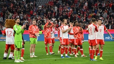 Bayern Munich players celebrate in front of fans after the match (REUTERS)