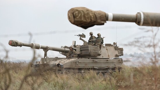 Israeli army soldiers are positioned with their armoured vehicles near the border with the Gaza Strip in southern Israel on October 9, 2023. (AFP)