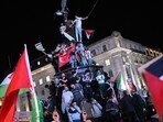 Pro-Palestine supporters wave flags and hold placards as they demonstrate at Piccadilly Circus in London. (AFP) Pro-Palestine supporters wave flags and hold placards as they demonstrate at Piccadilly Circus in London. (AFP)