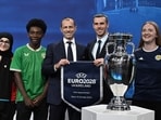 Welsh retired professional footballer, heading the delegation of UK and Ireland Gareth Bale (2ndR), flanked by UEFA president Aleksander Ceferin (C), poses next to the trophy with fans Welsh retired professional footballer, heading the delegation of UK and Ireland Gareth Bale (2ndR), flanked by UEFA president Aleksander Ceferin (C), poses next to the trophy with fans