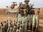 Artillery shells are lined up next to an armoured vehicle as Israeli soldiers take positions near the border with Gaza in southern Israel on October 9.