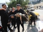 A Hamas police officer carries a wounded girl into a hospital in Beit Lahiya, Gaza Strip, on Sunday, A Hamas police officer carries a wounded girl into a hospital in Beit Lahiya, Gaza Strip, on Sunday,