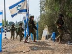 Israeli soldiers patrol an area in Kfar Aza, south of Israel bordering Gaza Strip Israeli soldiers patrol an area in Kfar Aza, south of Israel bordering Gaza Strip