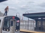 Man standing and running on the roof of a moving train in New York. 