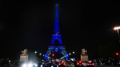 This photograph taken on October 9, 2023 shows the Eiffel Tower illuminated with the Star of David and the colours of national flag of Israel. (AFP) This photograph taken on October 9, 2023 shows the Eiffel Tower illuminated with the Star of David and the colours of national flag of Israel. (AFP)