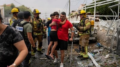 Israelis evacuate a site struck by a rocket fired from the Gaza Strip, in Ashkelon, southern Israel, Monday, Oct. 9, 2023. (AP) Israelis evacuate a site struck by a rocket fired from the Gaza Strip, in Ashkelon, southern Israel, Monday, Oct. 9, 2023. (AP)