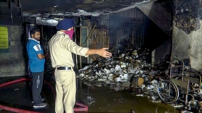 Police personnel inspects the charred remains after a fire broke out in the computer room of the PGI's Nehru Hospital, in Chandigarh on Tuesday early morning. (ANI)