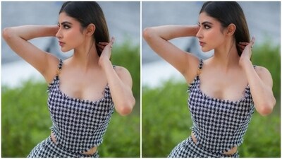 Mouni looked stunning as ever in a monochrome checkered slip top with an asymmetrical hem and cut-out details at the sides of the waist. She teamed it with a matching short skirt. (Instagram/@imouniroy) Mouni looked stunning as ever in a monochrome checkered slip top with an asymmetrical hem and cut-out details at the sides of the waist. She teamed it with a matching short skirt. (Instagram/@imouniroy)