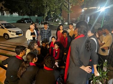 Huddled with the present members of Ibtida, Hindu's dramatics society, is Imtiaz Ali on the staircase of the college's Amphitheatre. (Photo: Kriti Kambiri/HT)