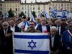 People hold and wave Israeli flags as they gather gather during a demonstration in a show of support for Israel, Tuesday in Lyon, central France. (AP)