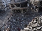 Israel Palestine Latest: Palestinians walk through the destruction by Israeli bombing in Gaza City. Israel Palestine Latest: Palestinians walk through the destruction by Israeli bombing in Gaza City.
