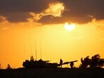 Israeli soldiers work on a tank near the Israeli Gaza border, Israel