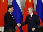 Russian president Vladimir Putin shakes hands with Chinese President Xi Jinping.