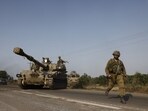 Israeli security forces and infantry fighting vehicles move towards the border with Gaza outside Sderot. Israeli security forces and infantry fighting vehicles move towards the border with Gaza outside Sderot.